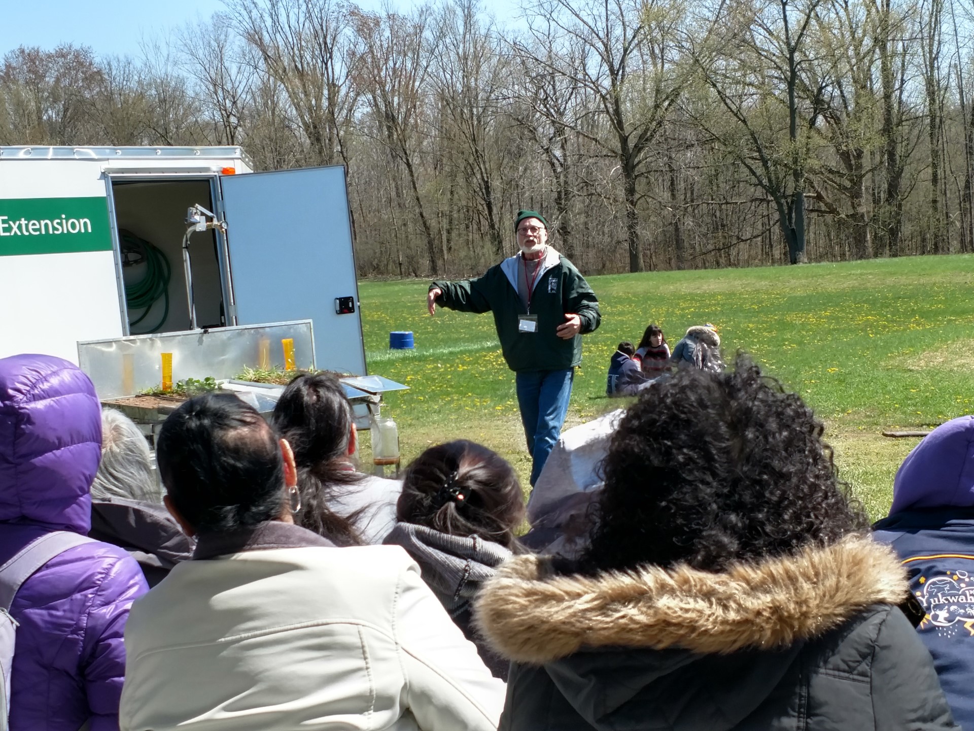 Dean Baas talks to people about a rainfall simulator.